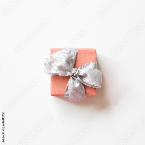 Pink gift box with silver ribbon isolated on white background. top view, copy space © Sanga