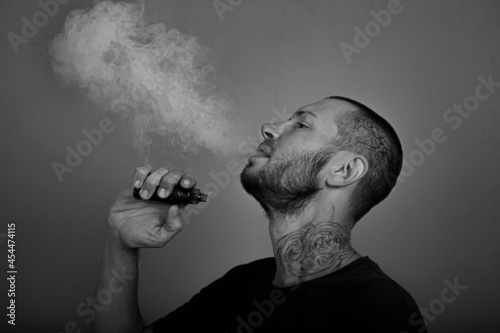 portrait of a young man with a cigarette in profile photo