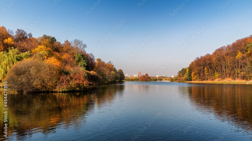 Beautiful autumn landscape, autumn park with reflection in the lake. 