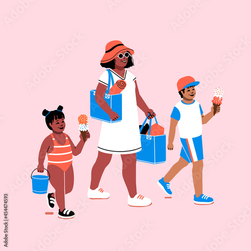 A single parent family going to the beach. Mom and kids on their way to a fun day by the sea, eating ice cream and carrying beach towels.