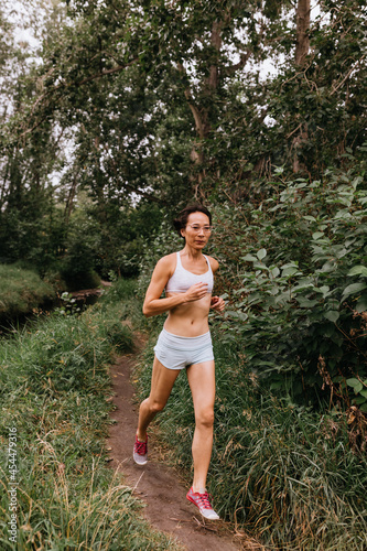 Chinese woman trail running in park