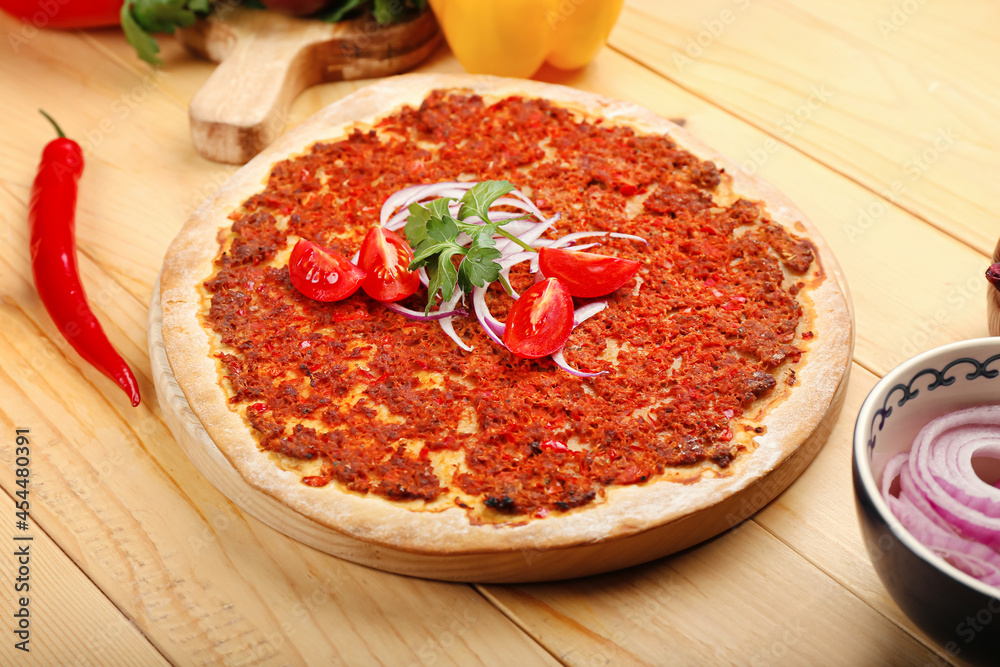 Board with delicious Turkish pizza on wooden background