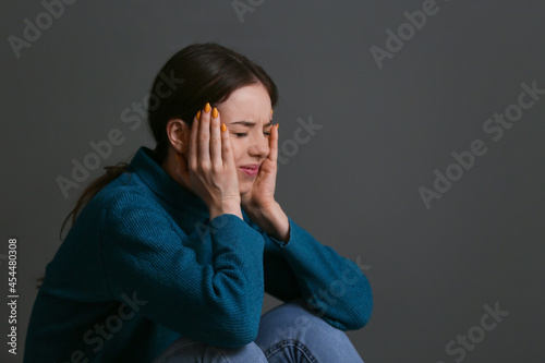 Depressed young woman on gr...