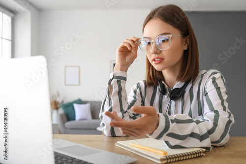Young woman with laptop at ...