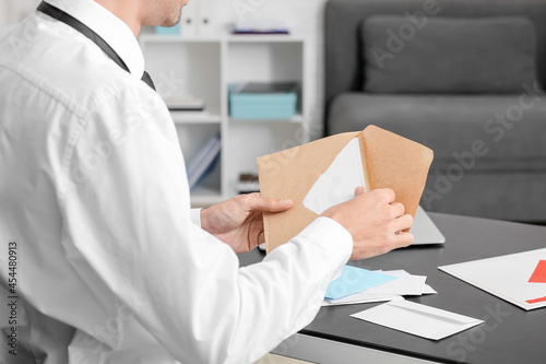 Young man with letter in of...