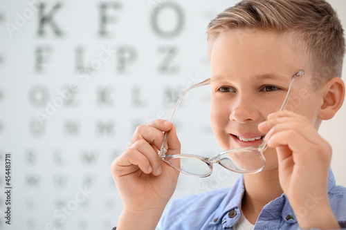 Little boy wearing glasses at ophthalmologist's office