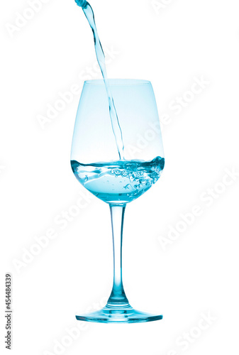 pouring water into wine glass isolated on white background