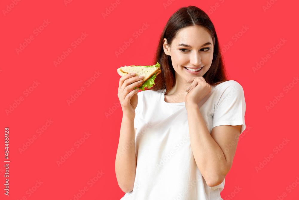Young woman with tasty sandwich on color background Young woman with tasty sandwich on color background