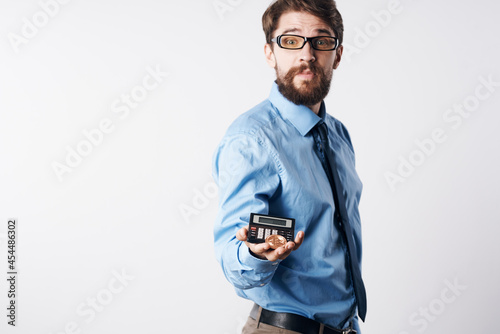 a man in a blue shirt with a calculator in his hands finance Professional