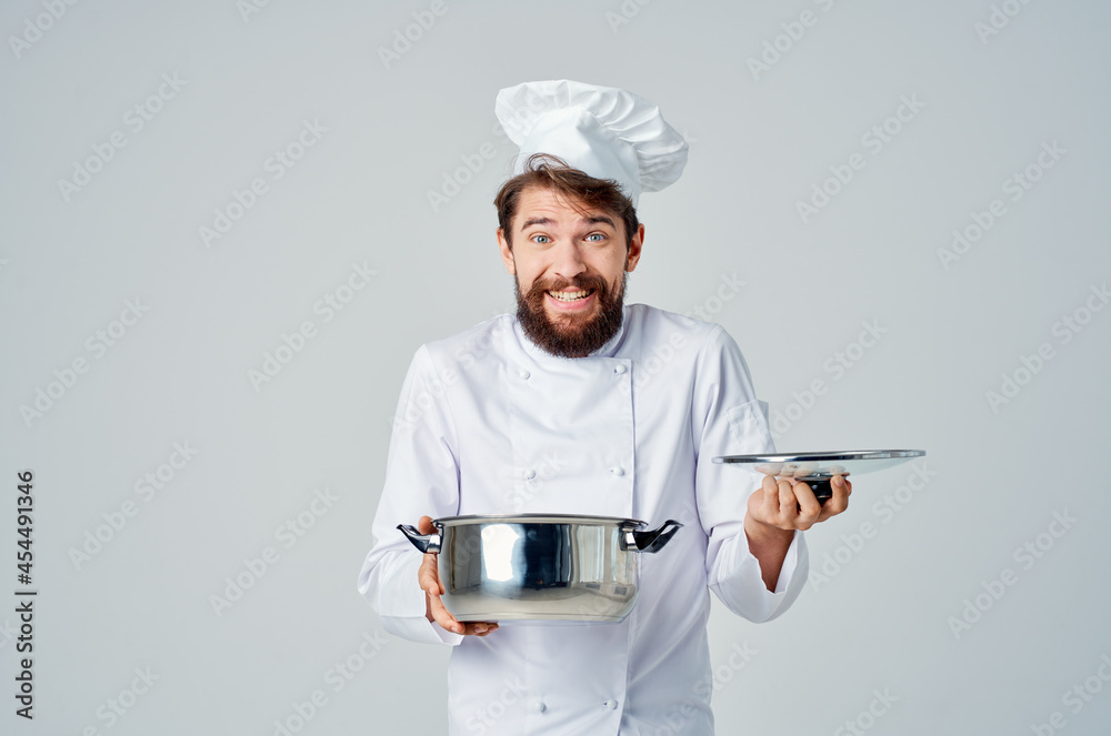 professional chef with a saucepan in his hands working in the kitchen professional chef with a saucepan in his hands working in the kitchen