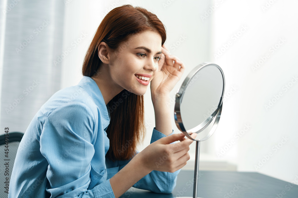 woman in front of the mirror cosmetics home care woman in front of the mirror cosmetics home care
