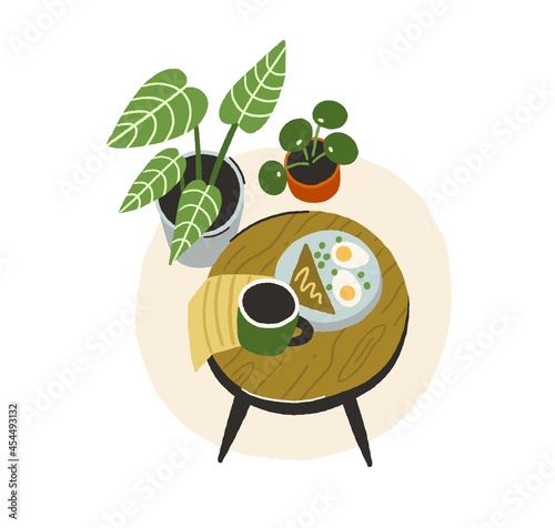 Breakfast on wood coffee table. Lunch with tea cup, sandwich, eggs on plate a...