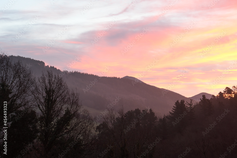 Reddish sunrise between the mountains