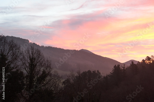 Fototapeta Naklejka Na Ścianę i Meble -  Reddish sunrise between the mountains