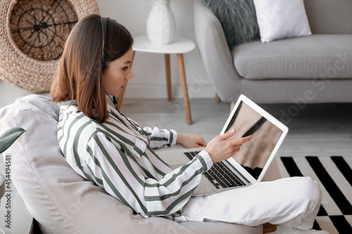 Young woman with laptop at ...