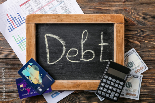 Debt word written on a chal...