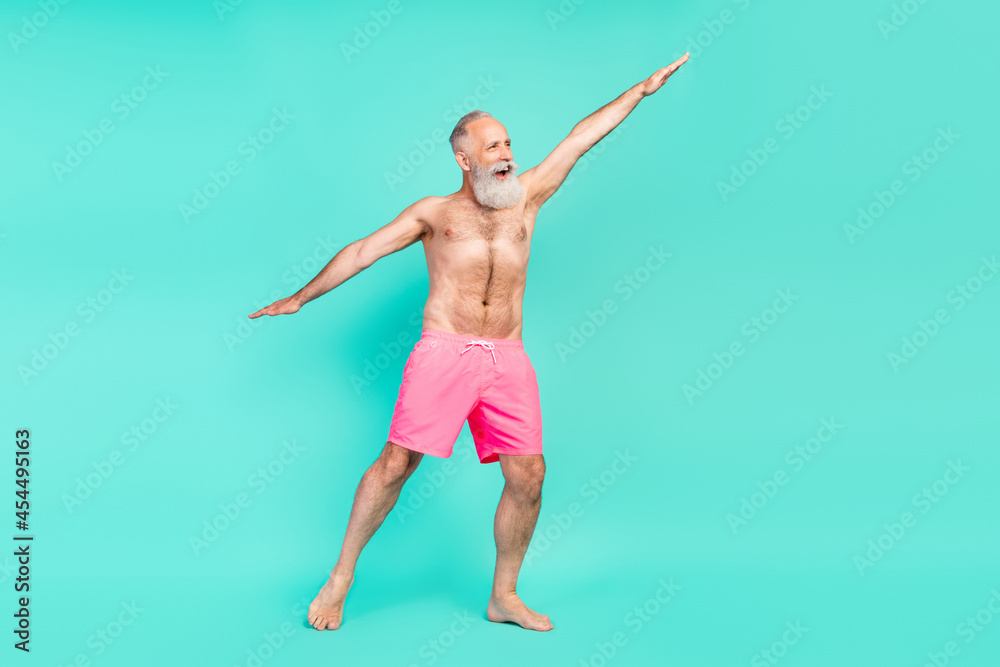 Photo of positive funny cheerful grandpa old man dance look empty space isolated turquoise color background