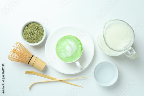 Matcha latte and accessories for making on white background