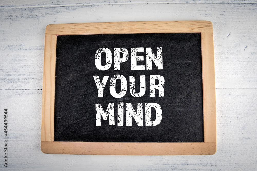 Open Your Mind. Chalk board on a white painted wooden background