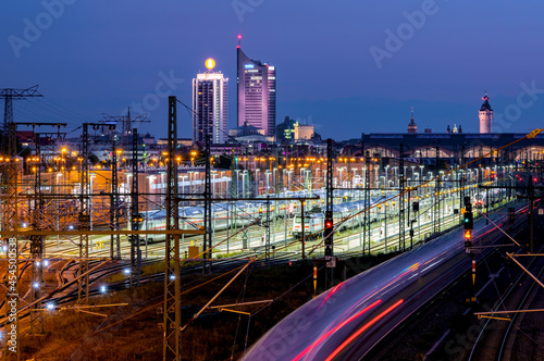 Cityscape of Leipzig (Germany) at the blue hour with main station and incoming train.