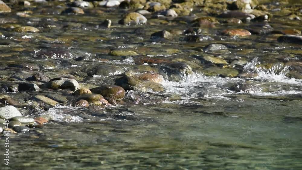 The flow of a mountain river over stones. Close-up The flow of a mountain river over stones. Close-up