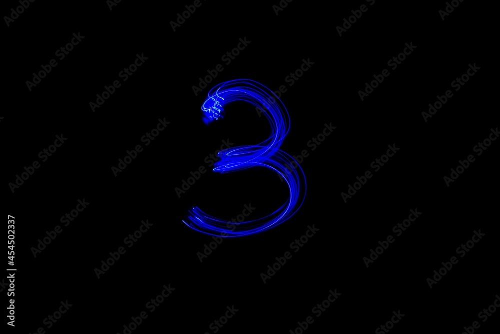 Number 3, long exposure photo of blue lights, light painting. Number 3, long exposure photo of blue lights, light painting.