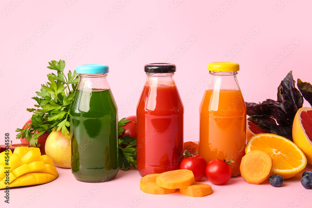 Bottles with healthy juice, fruits and vegetables on color background Bottles with healthy juice, fruits and vegetables on color background