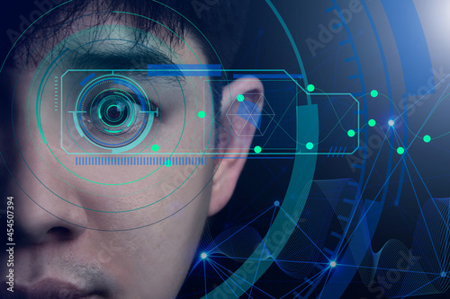 concept of AI computer system, facial recognition with an eye scan. Creative innovation in designing technology of the future. Close-up of a handsome Asian man's face on a dark background.