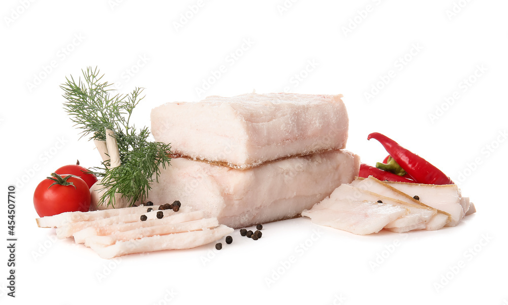 Pieces of salted lard with fresh vegetables on white background