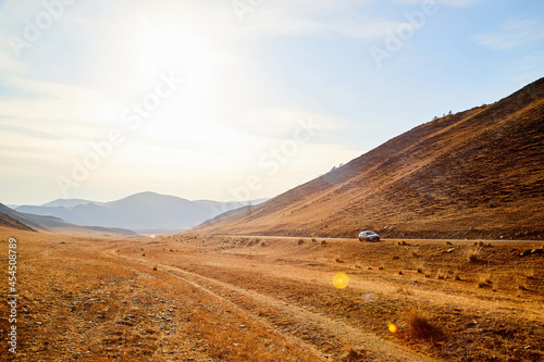 Nature landscape with golden hills with a blue sky with white clouds in a day or a evening