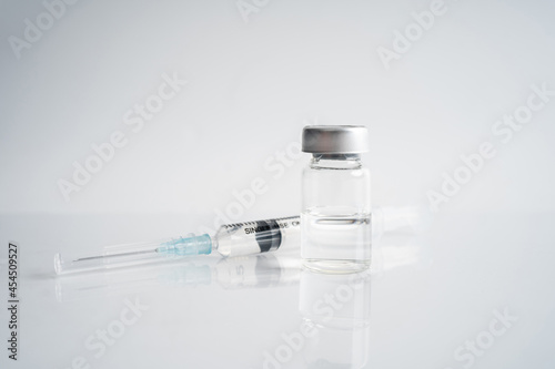 Syringe and vials, isolated on white background