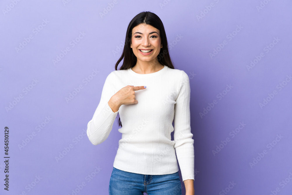 Young brunette woman over isolated purple background with surprise facial expression Young brunette woman over isolated purple background with surprise facial expression
