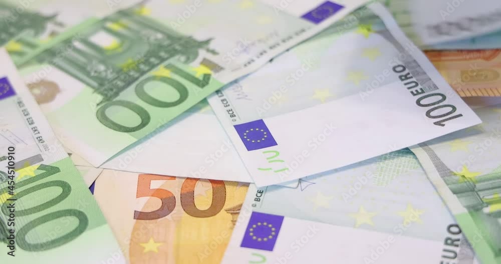 Euro banknotes on table. Slow motion of euros are falling. Close up of euro cash money background, good earnings Euro banknotes on table. Slow motion of euros are falling. Close up of euro cash money background, good earnings