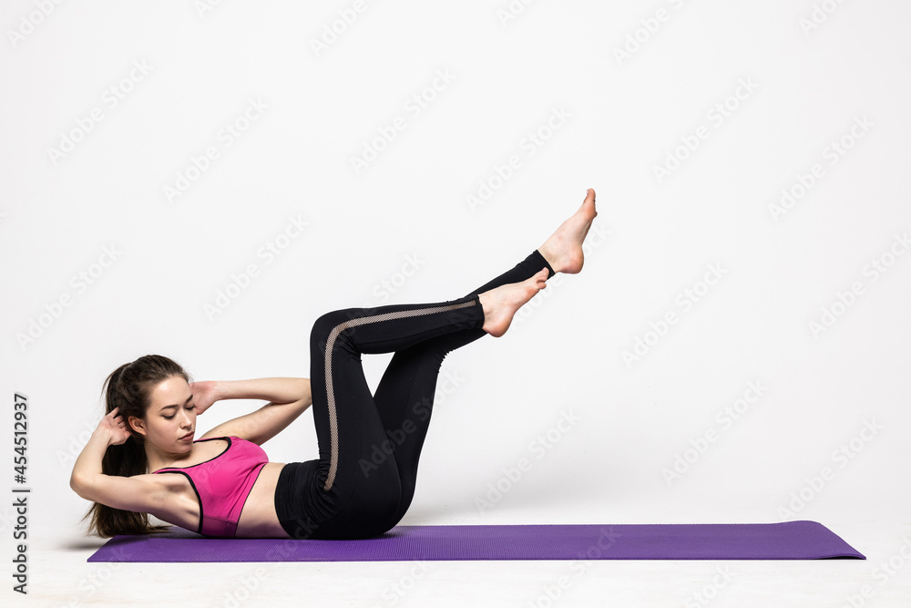 Beautiful young woman doing fitness exercise on white background. Fitness and healthy lifestyle concept Beautiful young woman doing fitness exercise on white background. Fitness and healthy lifestyle concept