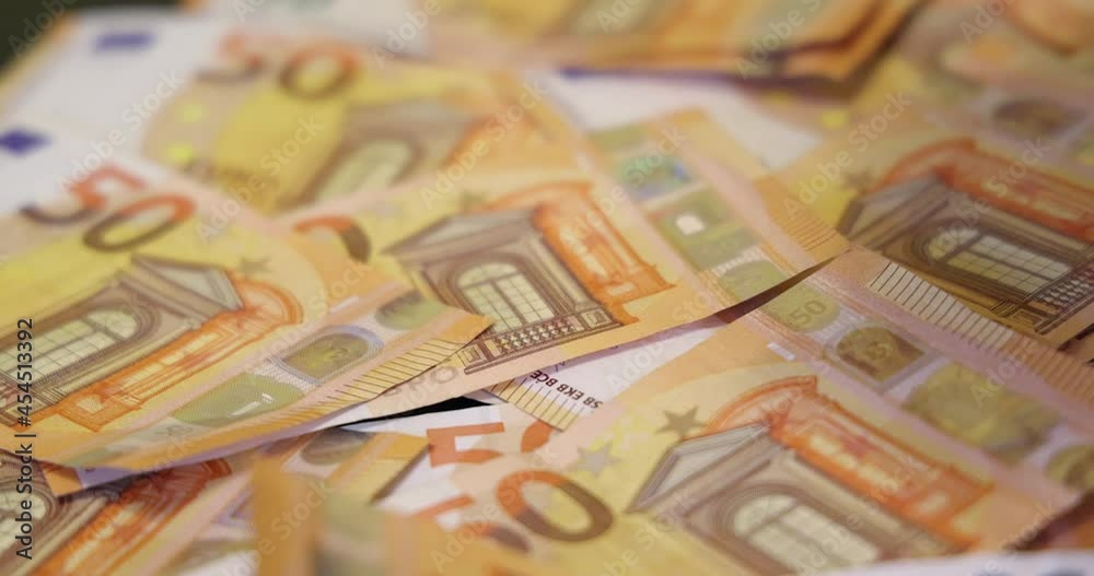 Euro banknotes on table. Slow motion of euros are falling. Close up of euro cash money background, good earnings Euro banknotes on table. Slow motion of euros are falling. Close up of euro cash money background, good earnings