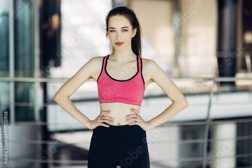 portrait of a pretty sporty woman standing at gym