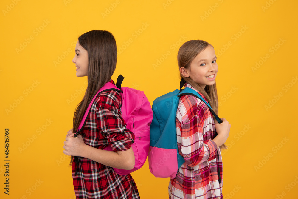 smiling children in casual checkered shirt carry backpack, september smiling children in casual checkered shirt carry backpack, september