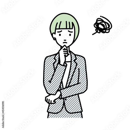 立って手をあごにあてて困っているスーツの女性