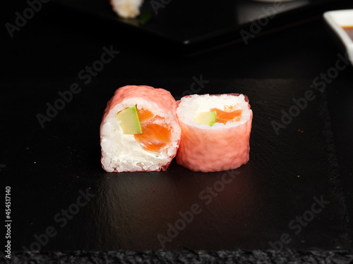 Traditional japanese nigiri sushi, separated on black stone background