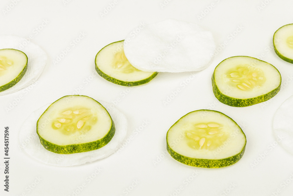 Cucumber slices and cotton pads isolated on white background Cucumber slices and cotton pads isolated on white background