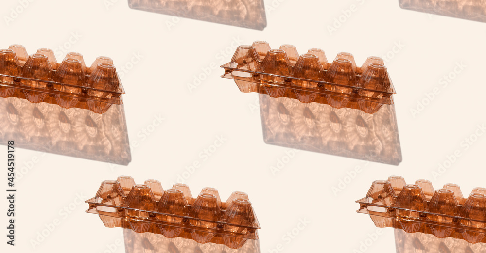 Pattern from empty plastic egg container isolated on gray background. Recyclable material. Waste sorting. Pattern, banner. Recycle Week Pattern from empty plastic egg container isolated on gray background. Recyclable material. Waste sorting. Pattern, banner. Recycle Week