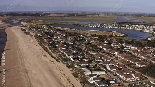Aerial footage along Pagham beach in West Sussex, with the Pagham Lagoon and Holiday Park in view next to the nature reserve.