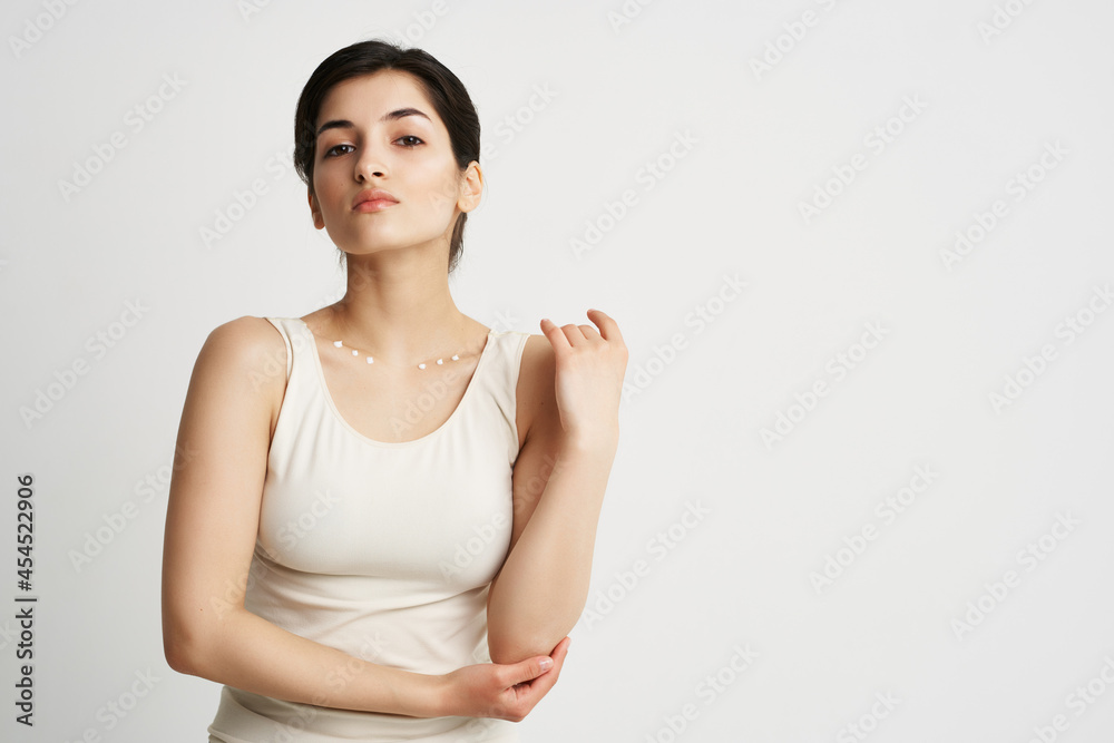 pretty brunette in white tank top cream moisturizing skin care pretty brunette in white tank top cream moisturizing skin care