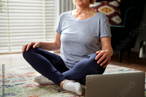 Unrecognizable active senior woman at home photo