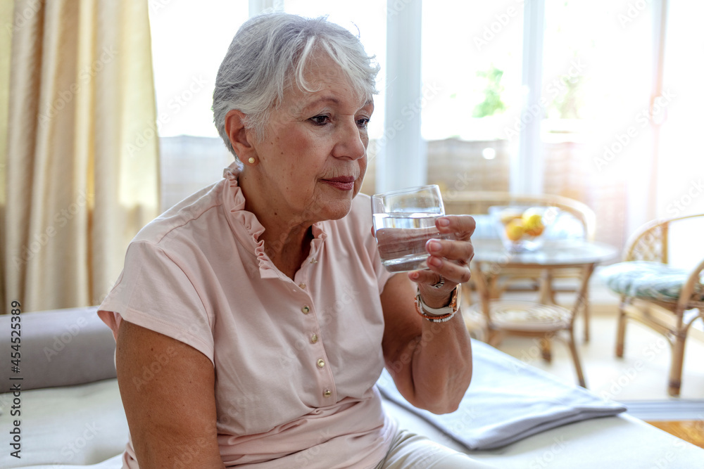 Cropped shot of a elderly woman drinking a glass of water at home. Senior woman with glass of water at home, age, healthcare and people concept. Shot of a healthy old lady holding a glass of water. Cropped shot of a elderly woman drinking a glass of water at home. Senior woman with glass of water at home, age, healthcare and people concept. Shot of a healthy old lady holding a glass of water.
