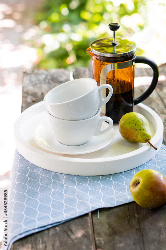 Fototapeta premium Breakfast serving for two, tea cups and fruits