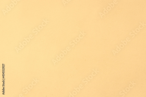 Light yellow cream color surface background wall texture for text and design
