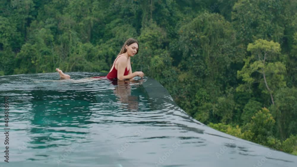 travel woman relaxing in swimming pool wearing bikini enjoying vacation lifestyle at luxury hotel spa with view of tropical jungle 4k travel woman relaxing in swimming pool wearing bikini enjoying vacation lifestyle at luxury hotel spa with view of tropical jungle 4k