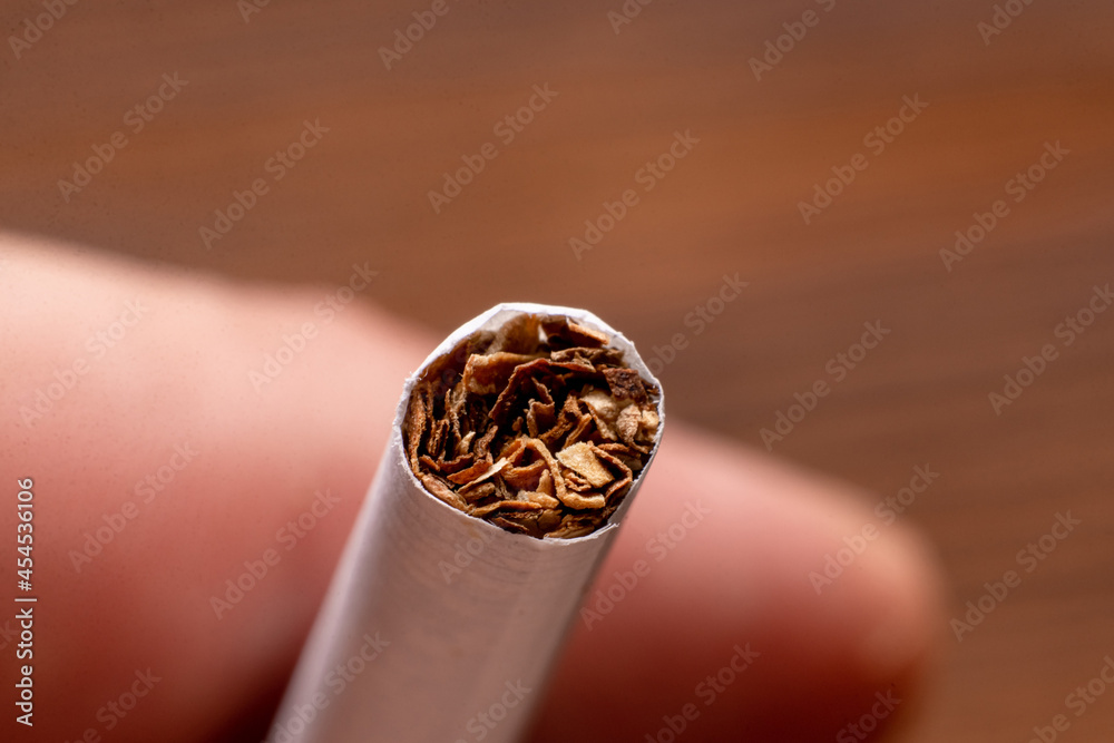 Cigarette close up on hand background. Cigarette close up on hand background.