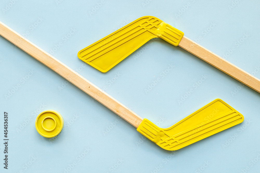 Competitive sports equipment with hockey sticks and puck. Top view Competitive sports equipment with hockey sticks and puck. Top view